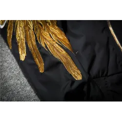 Black bomber jacket with embroidered golden wingsJackets