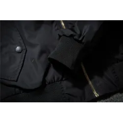 Black bomber jacket with embroidered golden wingsJackets